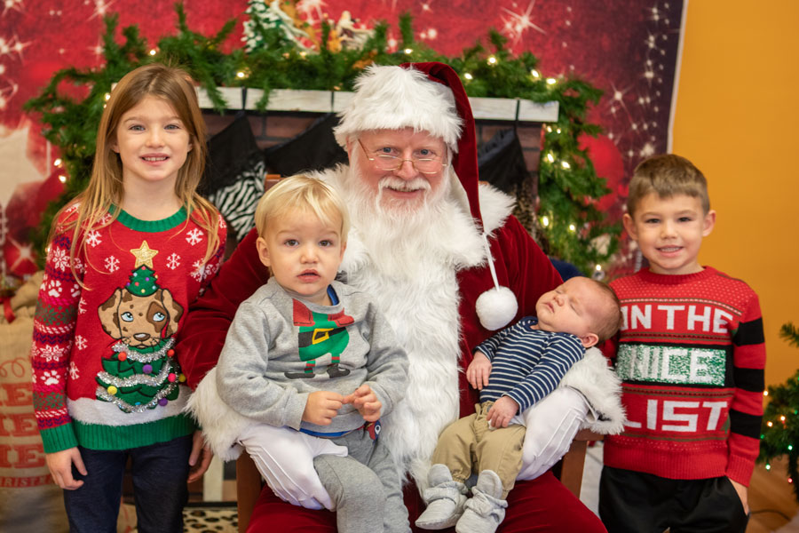 group of young kids visiting Santa at the Zoo